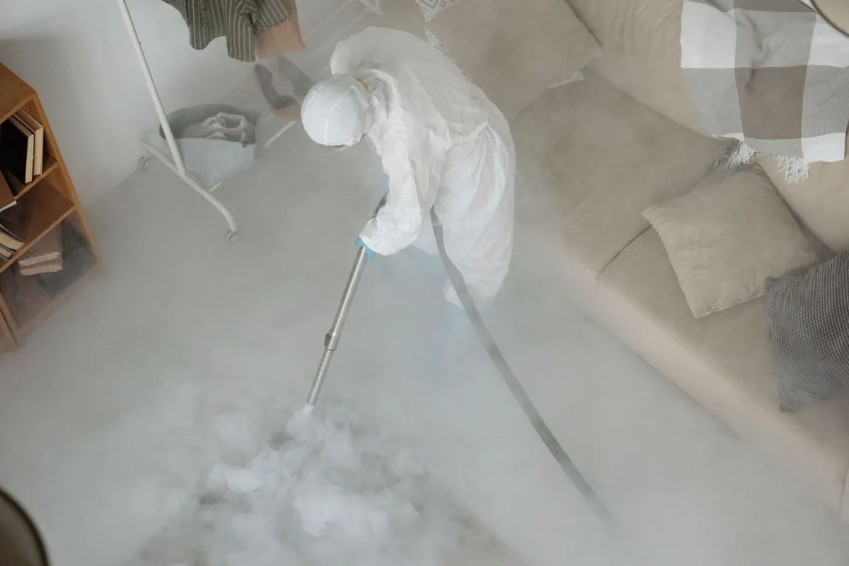 Biohazard cleanup technician in protective equipment, Kinsley, KS